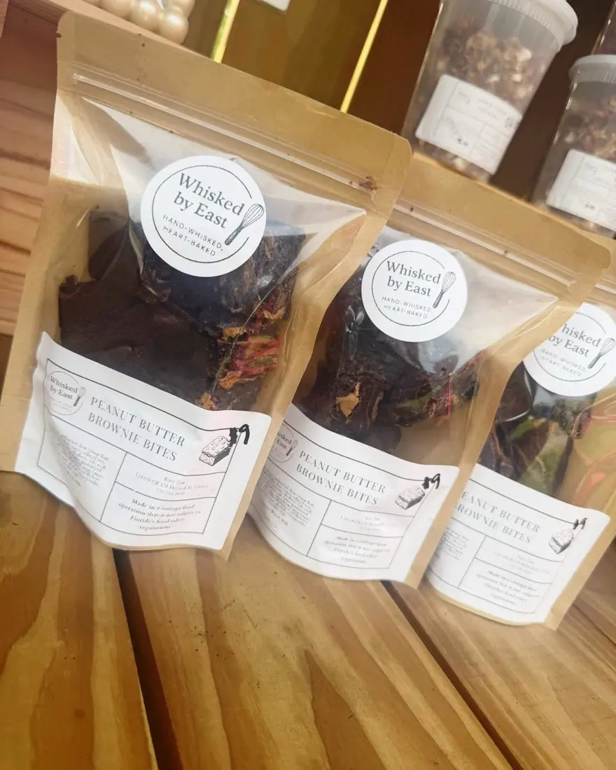 Kraft pouches of peanut butter brownie bites with round Whisked by East labels