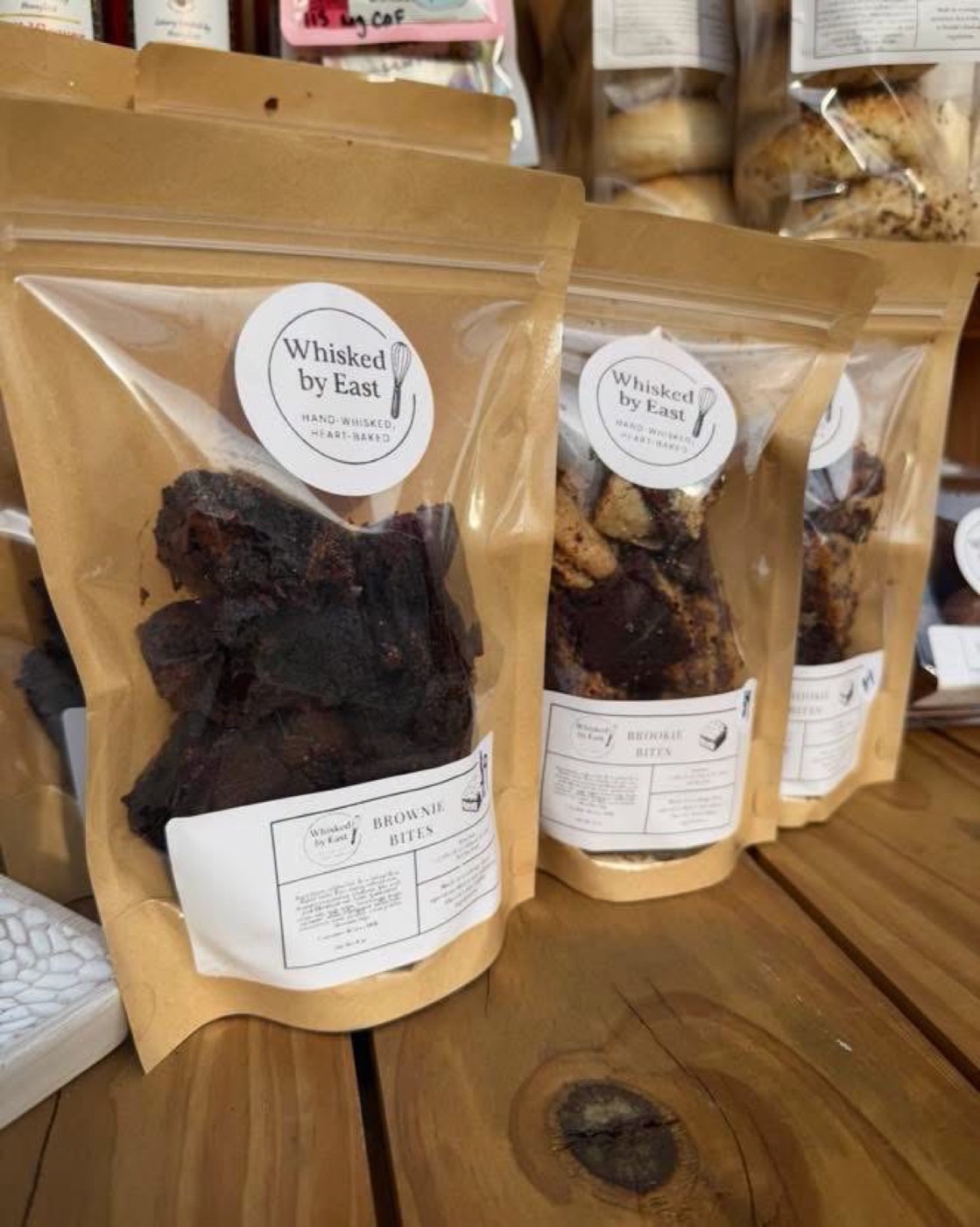 Kraft pouches of brownie bites with round Whisked by East labels