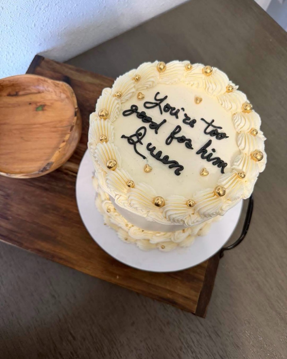 A vintage-piped buttercream cake topped with gold pearls and handwritten black lettering